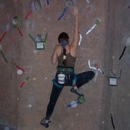 Put all your weight on that foot, hug the wall with your body,and reach up