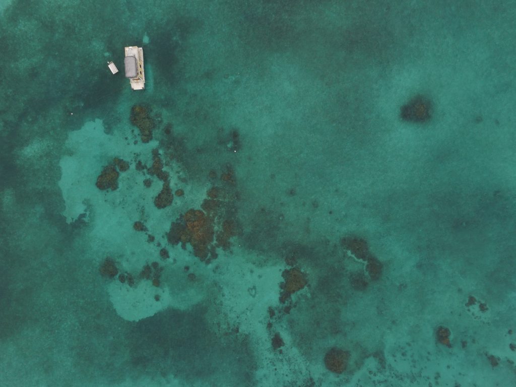 Several coral mounds in the Mexico Rocks area with a SNUBA boat (don't ask) in the upper left corner. Taken from the air with a drone.